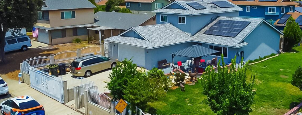 Solar panels installed on a residential rooftop under clear blue sky