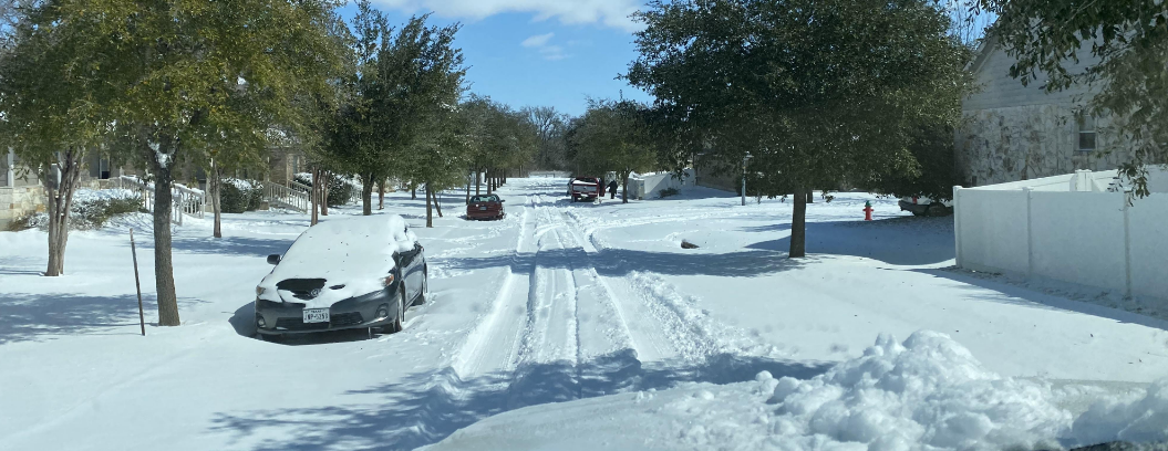 Winter storm with snow and ice covering neighborhood