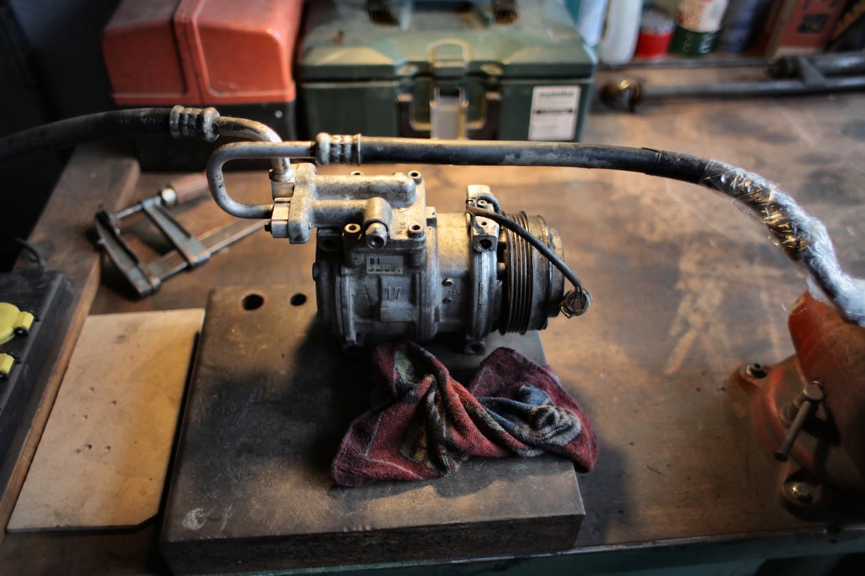 Air compressor and pipework on a workshop bench