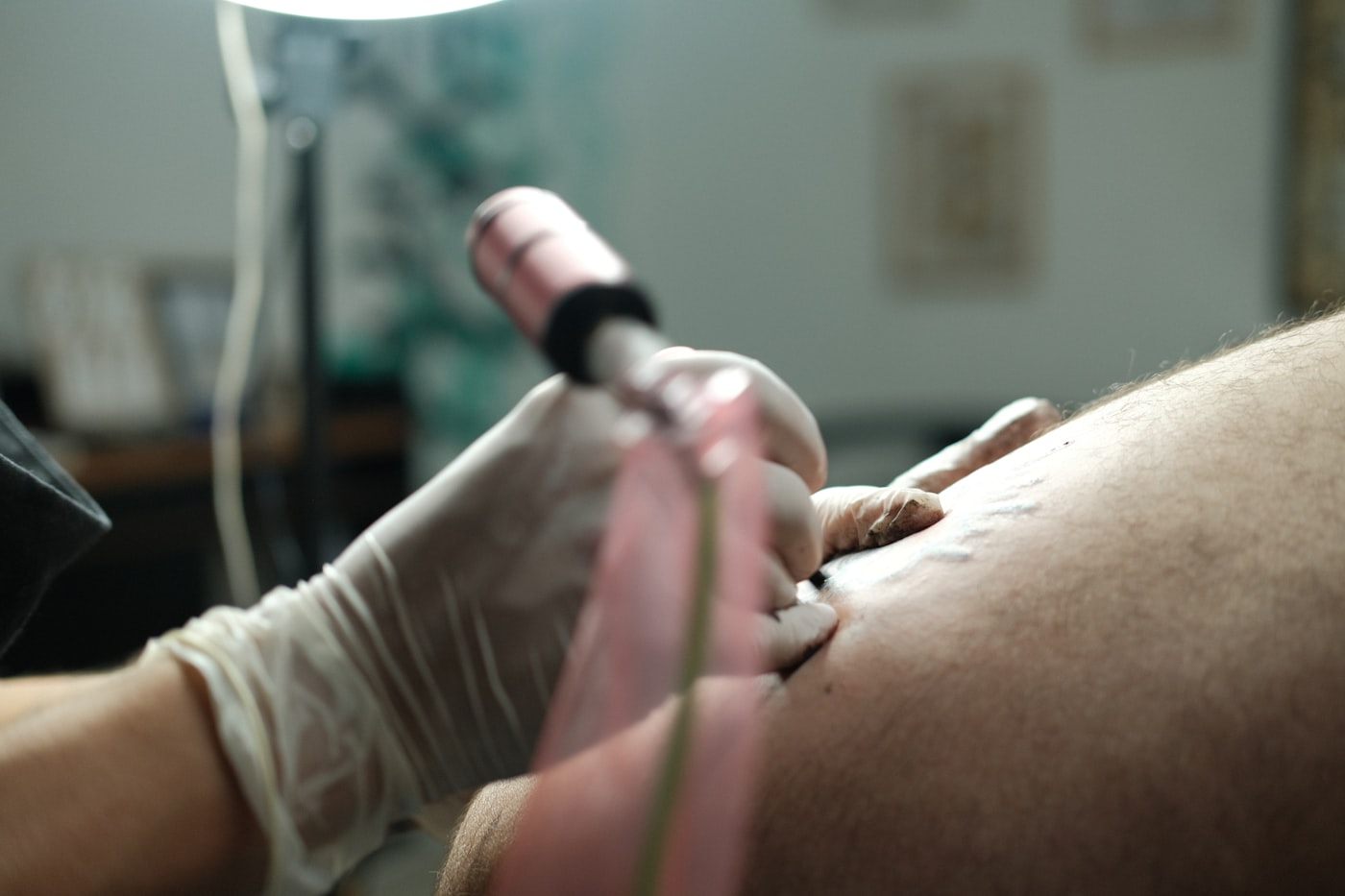 handheld ultrasound probe scanning a patient