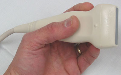 An ultrasound probe held in the hand, the whole imaging chain inside the handpiece
