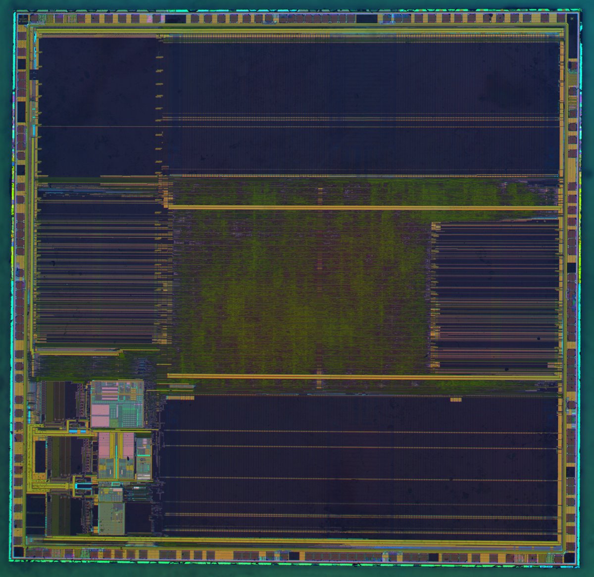 A die photograph of an STM32F103VG microcontroller, with large regular memory arrays covering most of the silicon