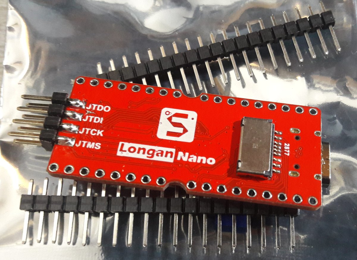 The back of a red Longan Nano board showing the Sipeed logo, a JTAG header, and the GD32VF103 chip