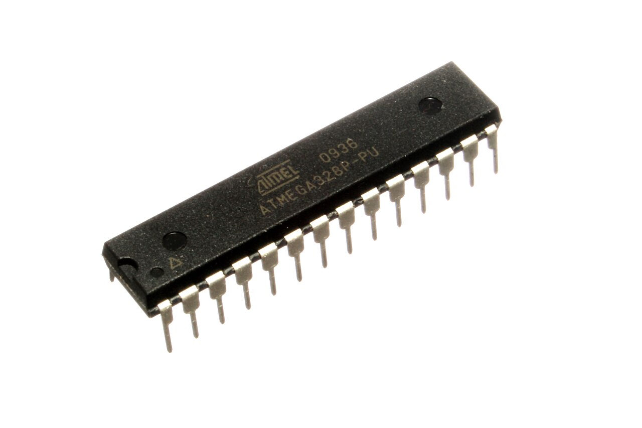 An Atmel ATmega328P-PU microcontroller in a 28-pin dual in-line package, the part marking ATMEGA328P-PU readable on its surface.