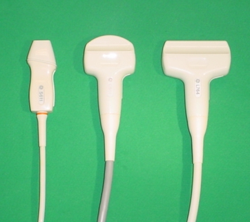 Three ultrasound probe types side by side, a sector, a convex and a linear scanner, each with its cable.