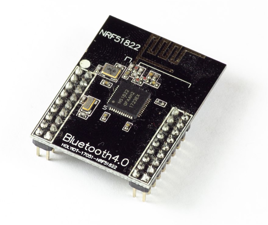 A Nordic nRF51822 Bluetooth Low Energy module, the QFN SoC marked N51822 beside a printed meander antenna on a black PCB.