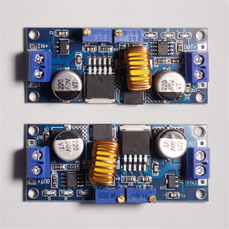 Two XL4015 buck converter modules, each with a toroidal inductor, large electrolytic capacitors and an adjustment potentiometer.