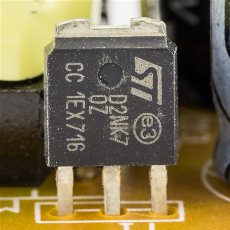 An ST STD2NK70Z N-channel MOSFET in a DPAK surface-mount package soldered to a circuit board.