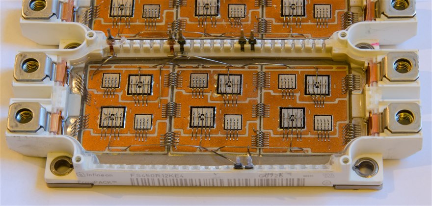 The inside of an Infineon EconoPACK IGBT module showing several IGBT and diode dies on a ceramic substrate.