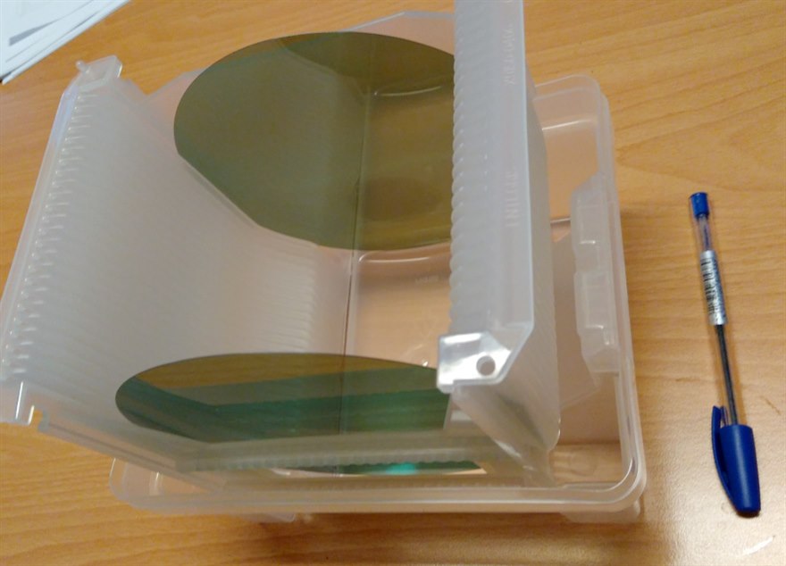 Silicon carbide wafers in a carrier, the mirror-finish discs the power dies are cut from.