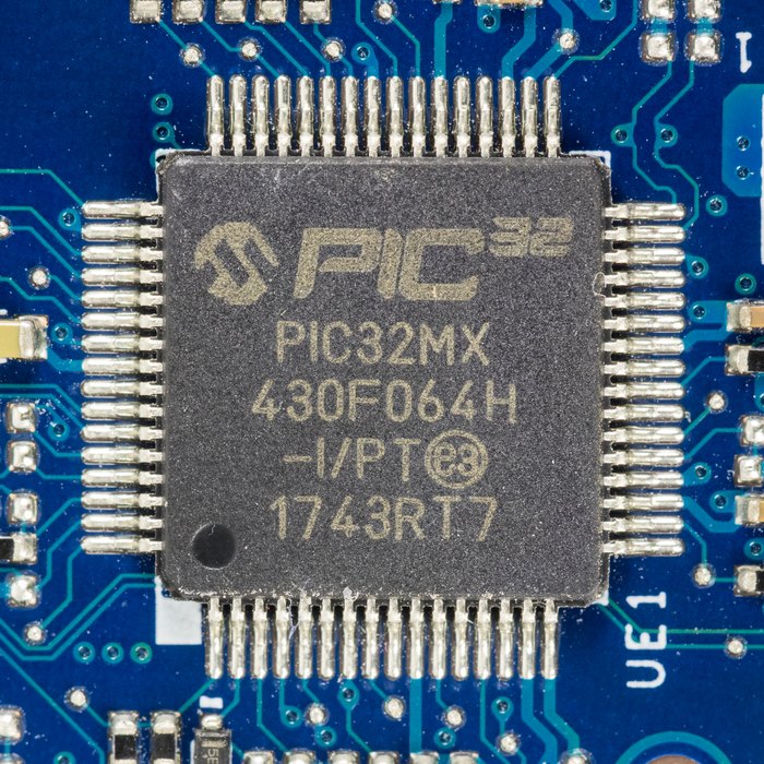 A Microchip PIC32MX430F064H microcontroller marked with the PIC32 logo on a circuit board