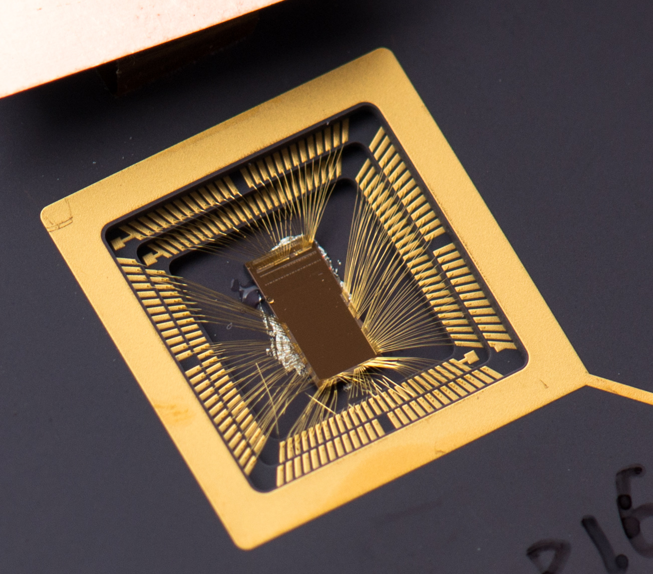 An early RISC-V prototype chip, a small die wire-bonded into a gold package leadframe