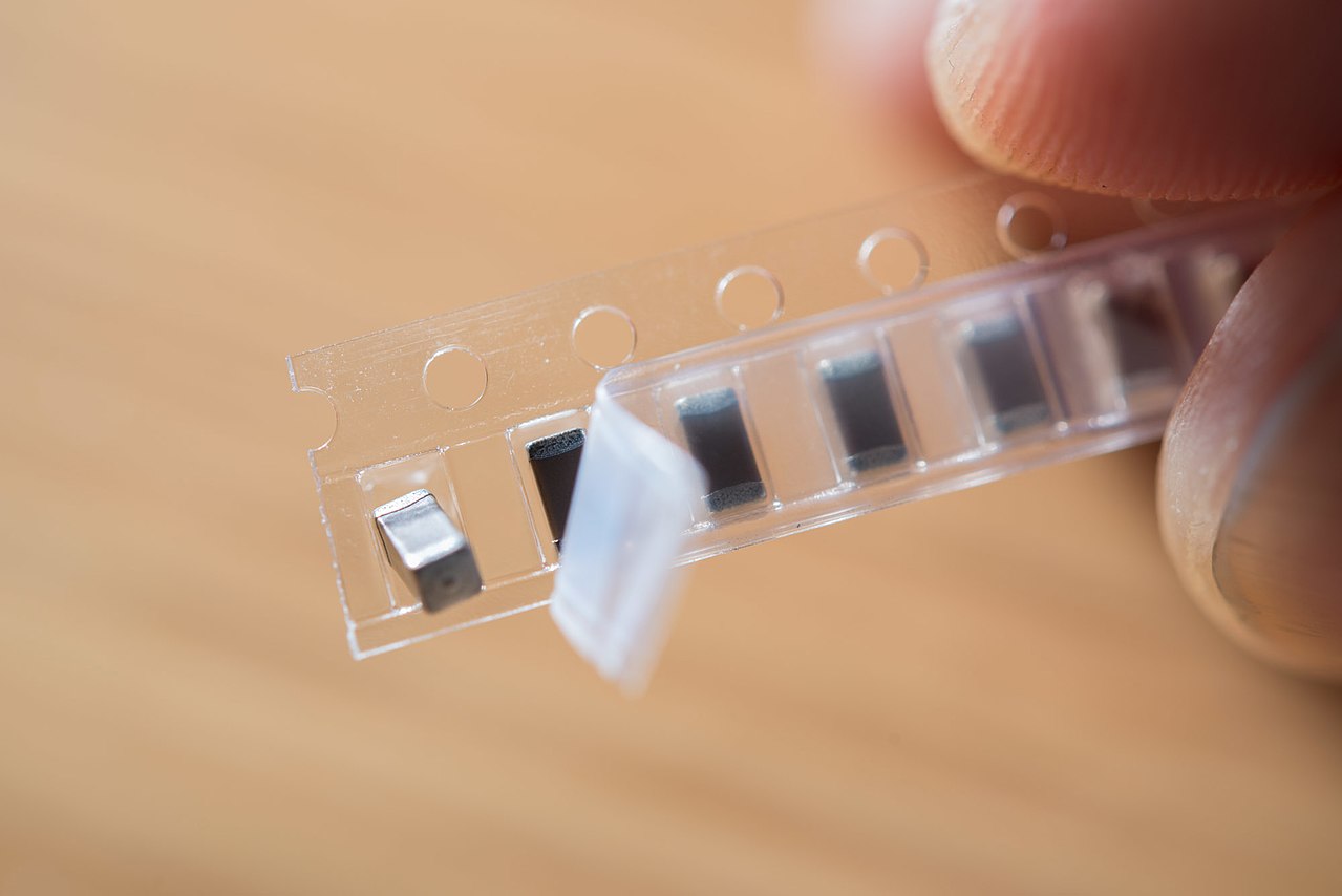 Surface-mount components in carrier tape, like the reel a microcontroller ships on