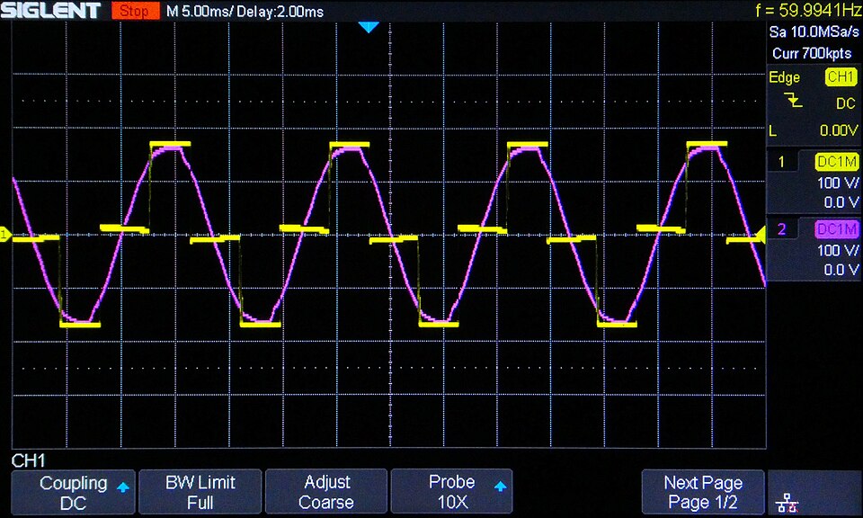 Oscilloscope screen showing a stepped non-sinusoidal UPS output waveform at about 60 hertz