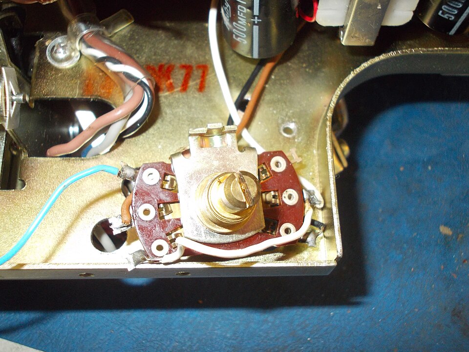 A real brass rotary mains voltage selector switch wired to transformer taps inside a device