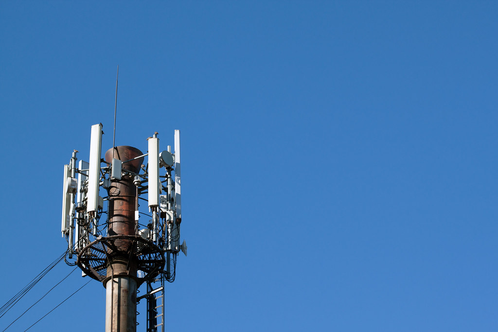 Cellular base station antennas on a telecom mast