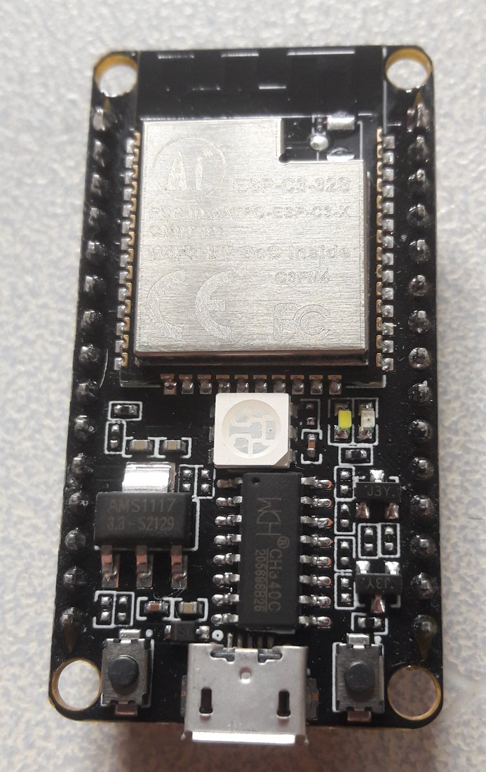 A black ESP32-C3 NodeMCU board with a metal-shielded ESP-C3-32S module, a CH340 chip, an RGB LED, and a micro-USB connector