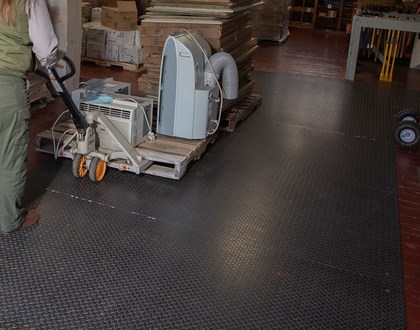 Pallet jack under a loaded pallet close view