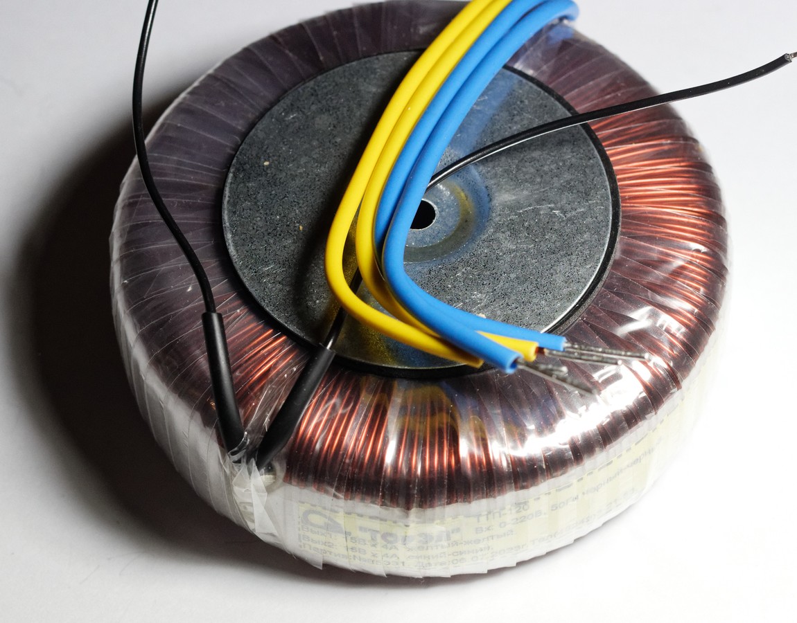 A 120 VA toroidal mains transformer with copper windings on an iron ring core and coloured lead wires