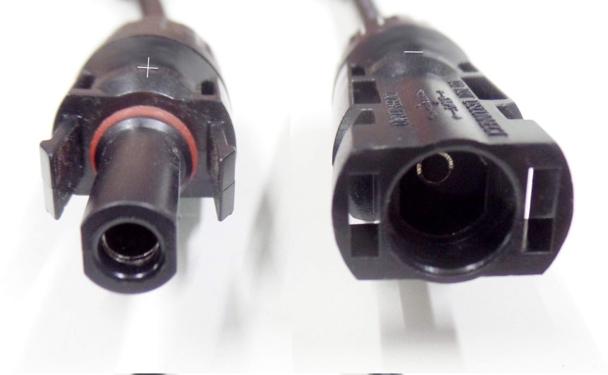 Male and female MC4 solar connector faces side by side, locking tabs visible, plus and minus marks moulded into the housings