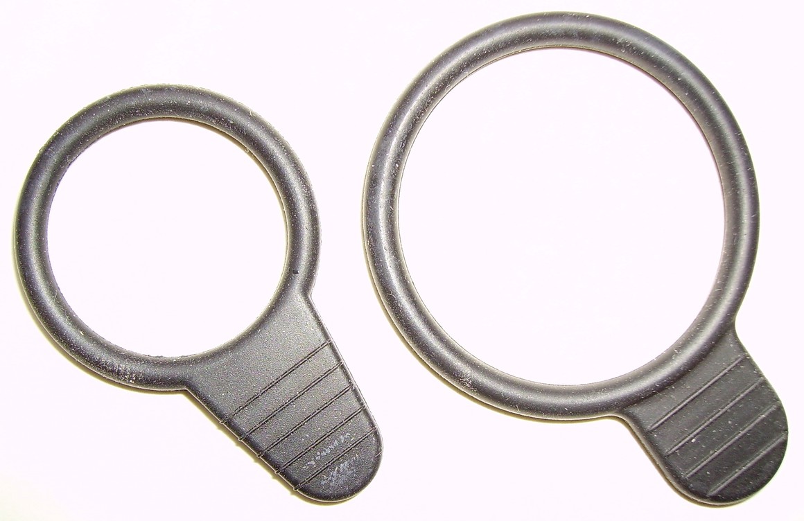 Two black rubber sealing rings with moulded pull tabs, the kind used on port plugs and caps