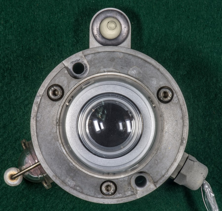 A thermopile pyranometer seen from above, its glass dome, spirit level and desiccant window visible in a machined housing