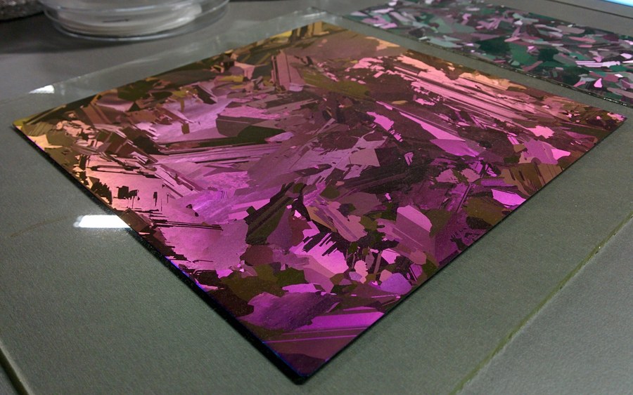 A bare multicrystalline silicon wafer with an anti-reflective film, its many crystal grains visible as irregular iridescent domains across the square surface